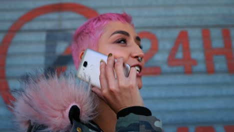 pink hair woman talking on mobile phone outside shop 4k