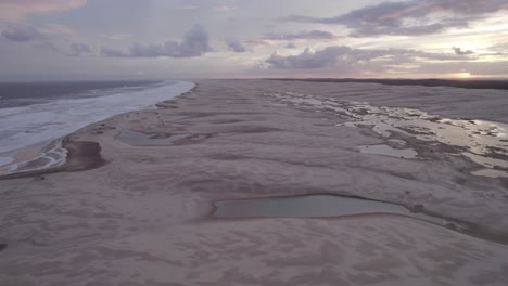 waves onto shore of stockton beach with sand dunes and lagoons in new south wales, australia