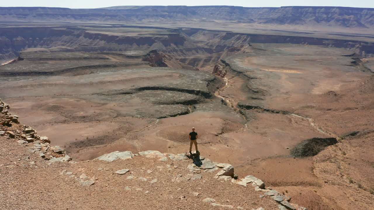 Man overlooking a vast canyon in the desert