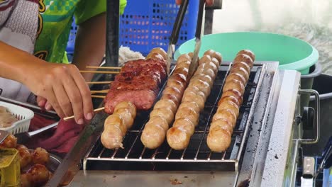 grilled sausages and meatballs at a street food stall