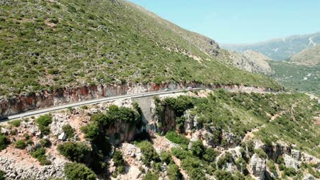 albania, cars driving on the road on a steep mountain slope, aerial view from a drone