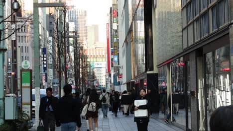 pedestrians walking on a busy urban sidewalk