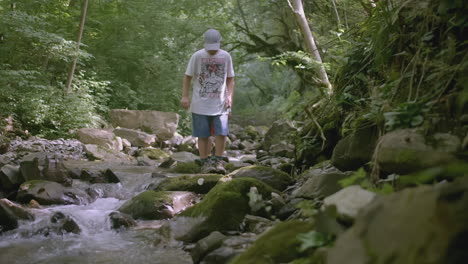 kids hiking through a forest creek