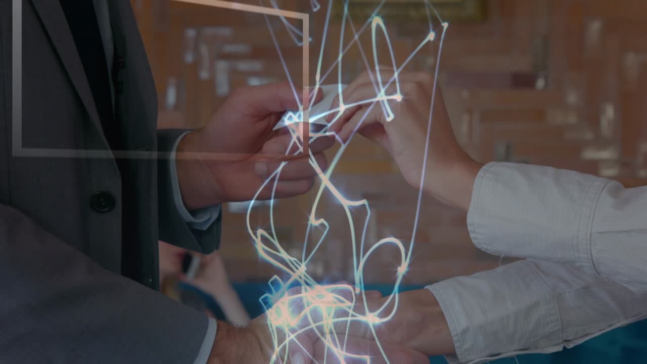 Glowing light trails over mid section of businessman and businesswoman shaking hands