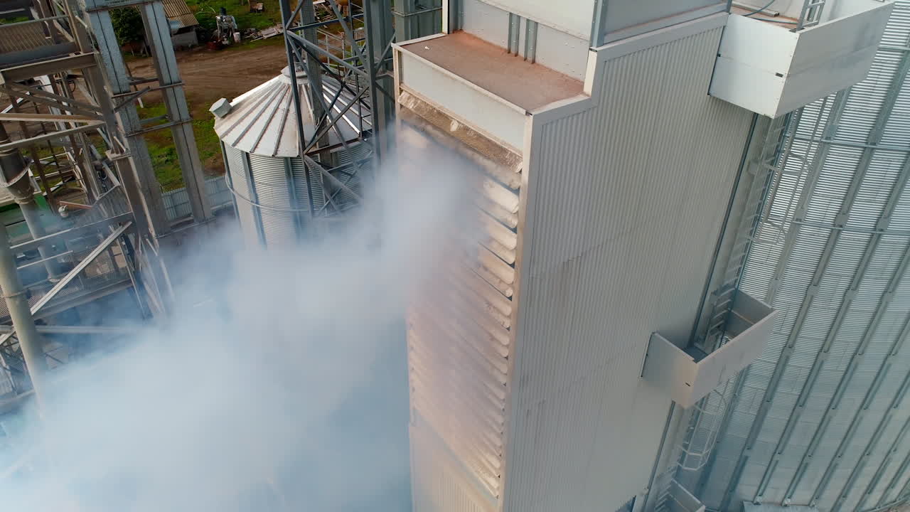 Thick smoke from factory. Chemical plant outdoors. Harmful manufacturing releases dangerous vapor into the air. Pollution of the environment. Aerial view.