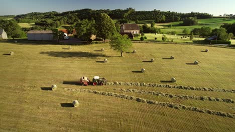 aerial view of tractor harvesting straw bales.