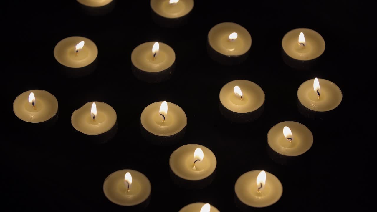 Candele Timelapse - Piccole candele che bruciano su sfondo nero