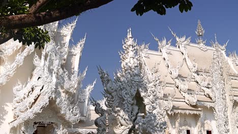 beautiful reveal of famous white temple in chiang rai, thailand on suny day