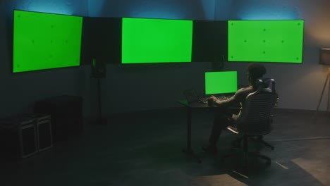 video editor at work in green screen studio