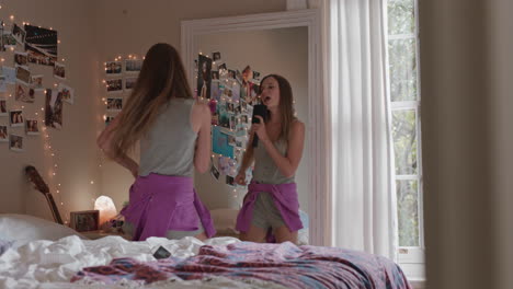 happy teenage girl dancing in bedroom enjoying music celebrating weekend having fun singing wearing pajamas at home day in the life of cheerful teen