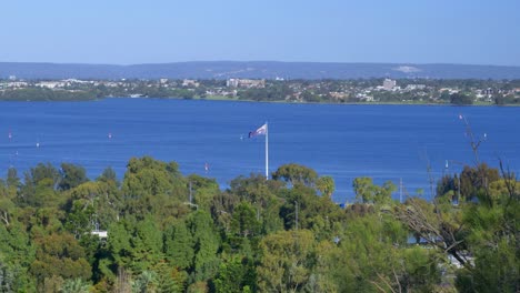 single australian flag flies over the bay of perth