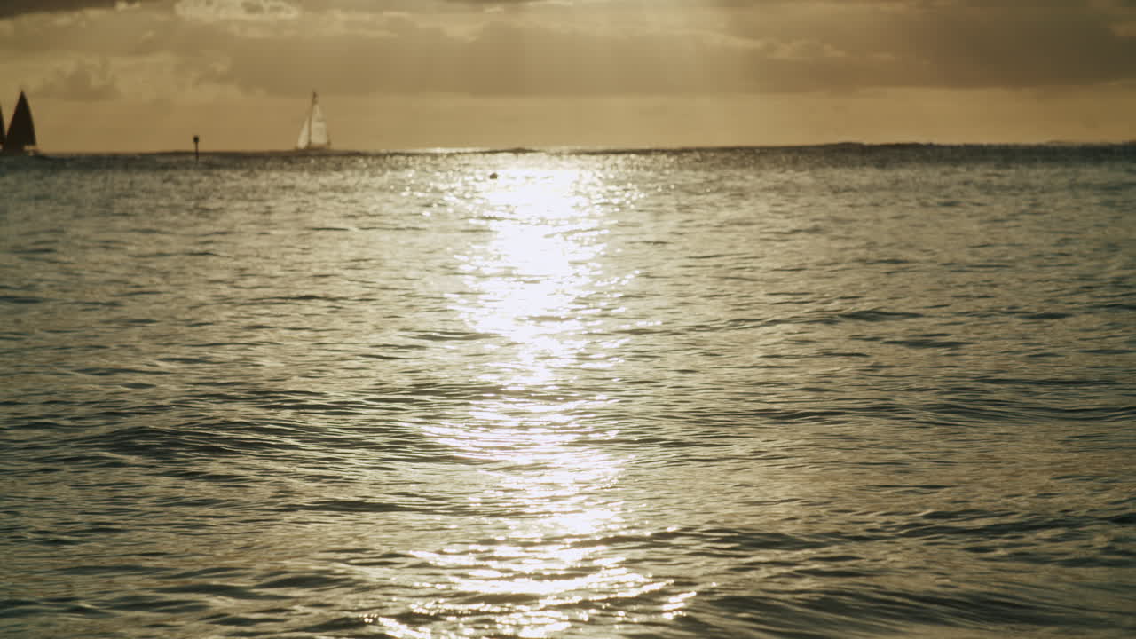 Golden Sunlight Reflecting on Calm Ocean Surface at Sunset