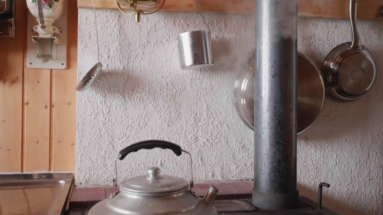 Old-fashioned kitchen decor with hanging utensils and a vintage oil lamp in Switzerland