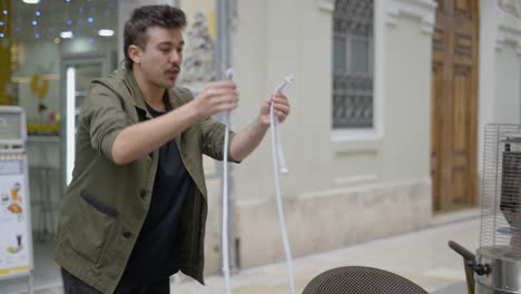 street magician performing rope magic