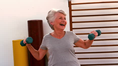 elderly woman working out with dumbbells