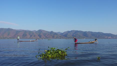 fishermen in a canoe fishing on famous inle lake