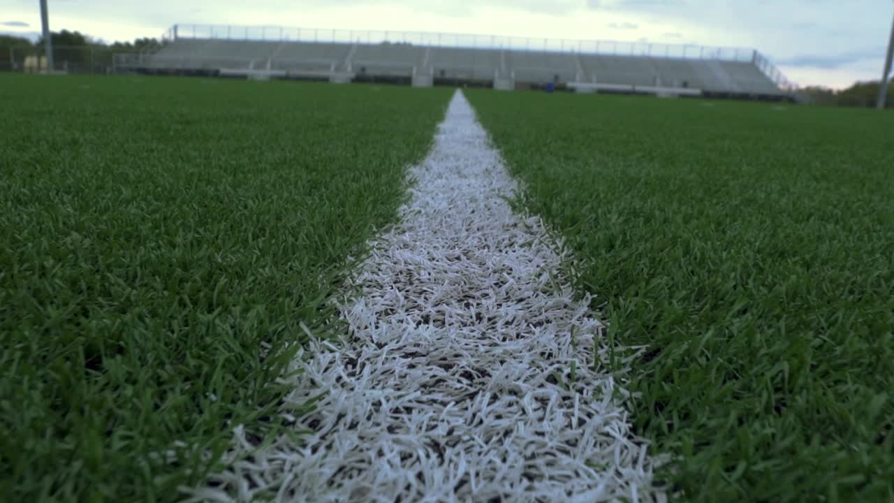 Tracking shot of a paint line at a sports field.