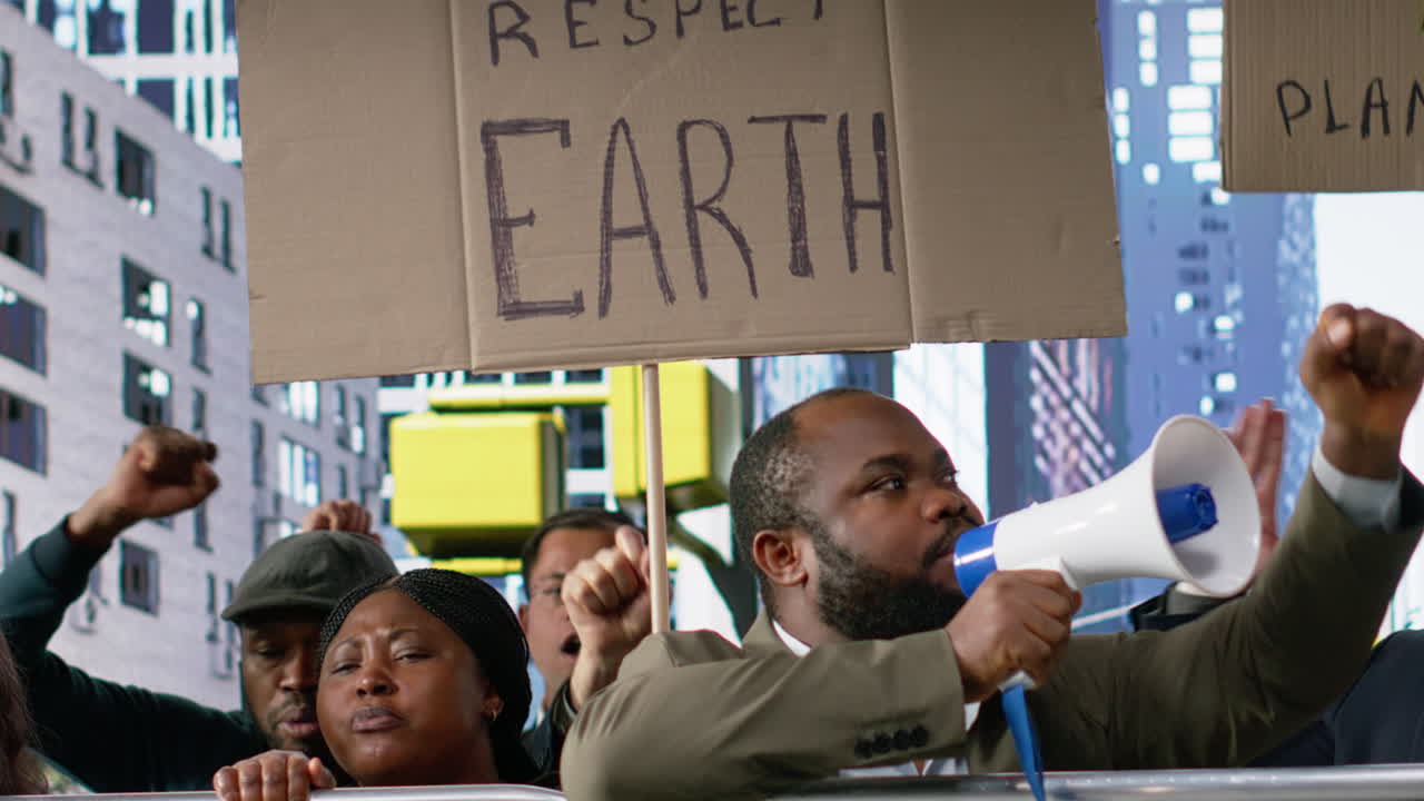 Diverse crowd of activists marching in a climate protest with banners