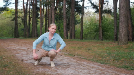 woman kneeling in a forest path