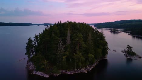 aerial sunset of forested island, hällingsjö, sweden