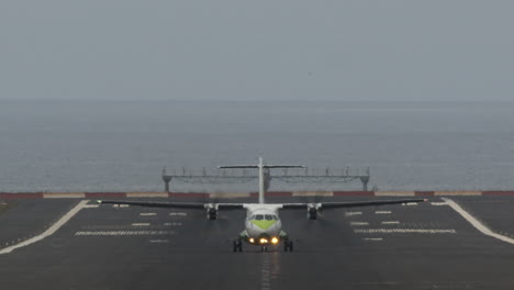 airliner departure from airport by the ocean