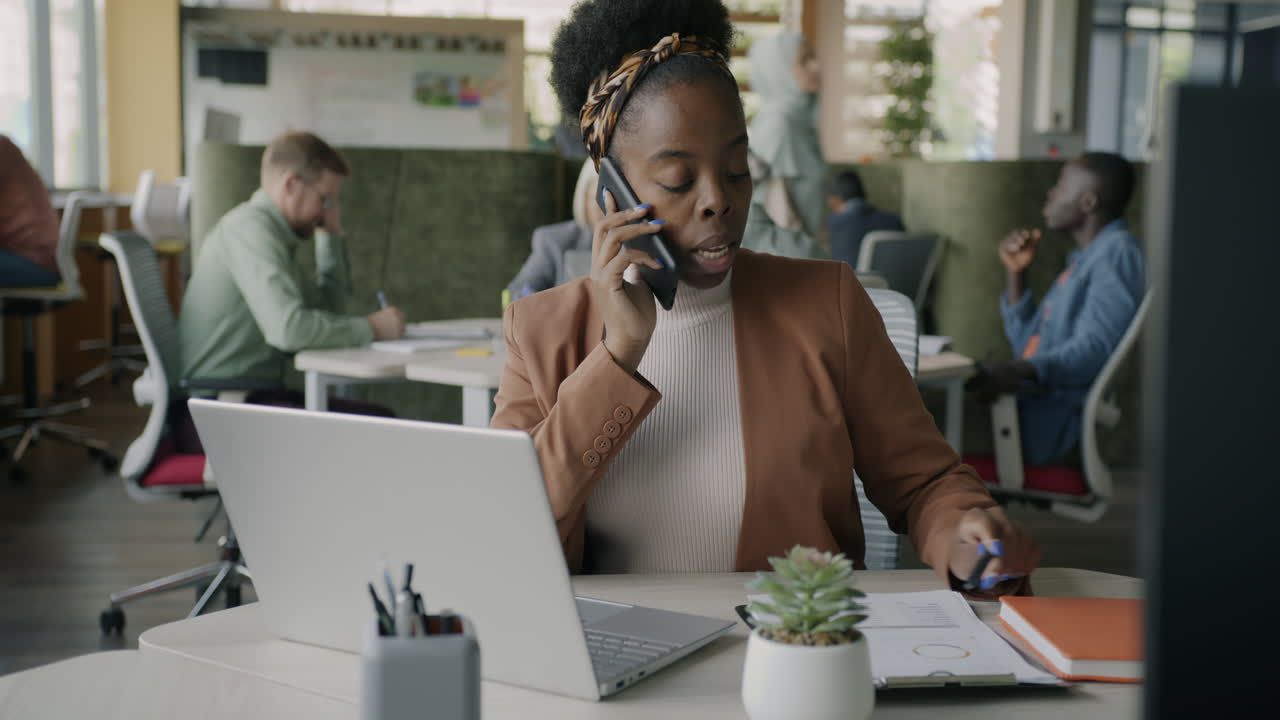 Businesswoman on Phone Call in Modern Office