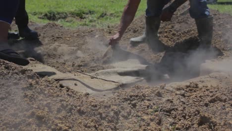 closeup of a hangi being prepared underground