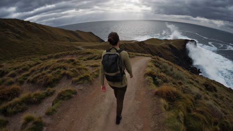 woman hiking along the ocean coast