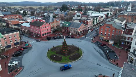 small american town during christmas time with christmas tree in center of roundabout