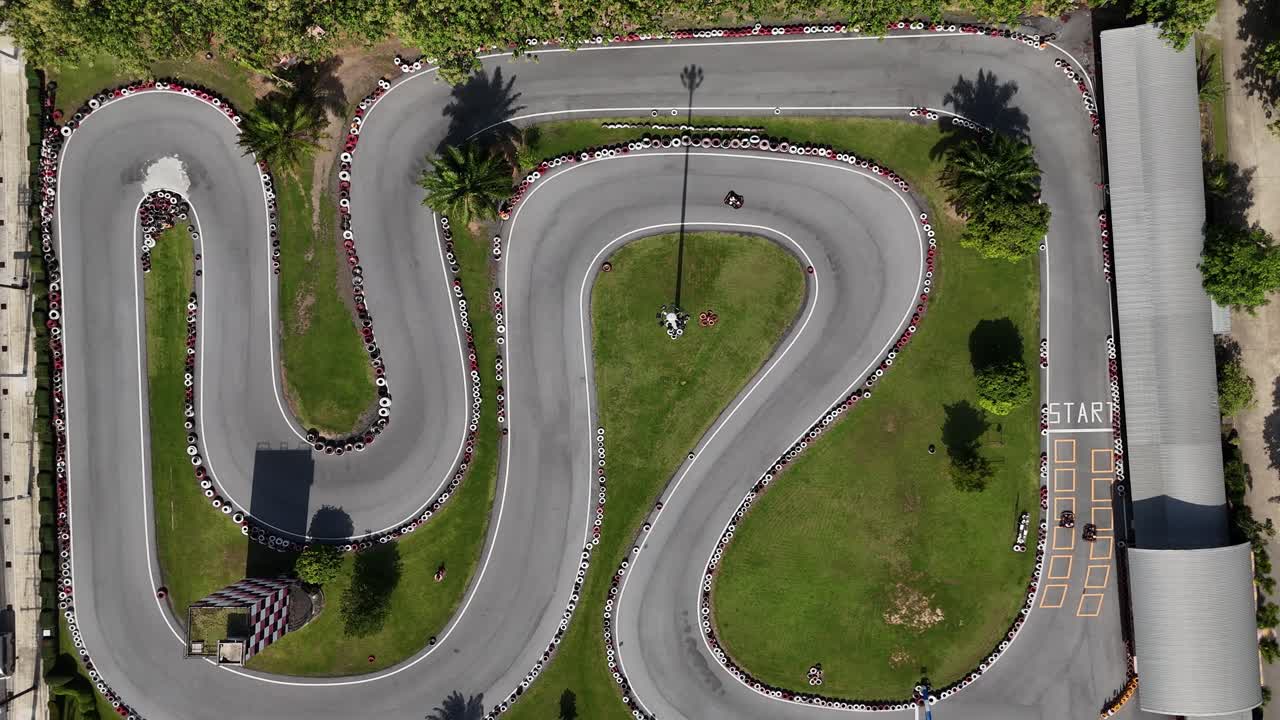 Aerial view of a go-kart track with cars racing