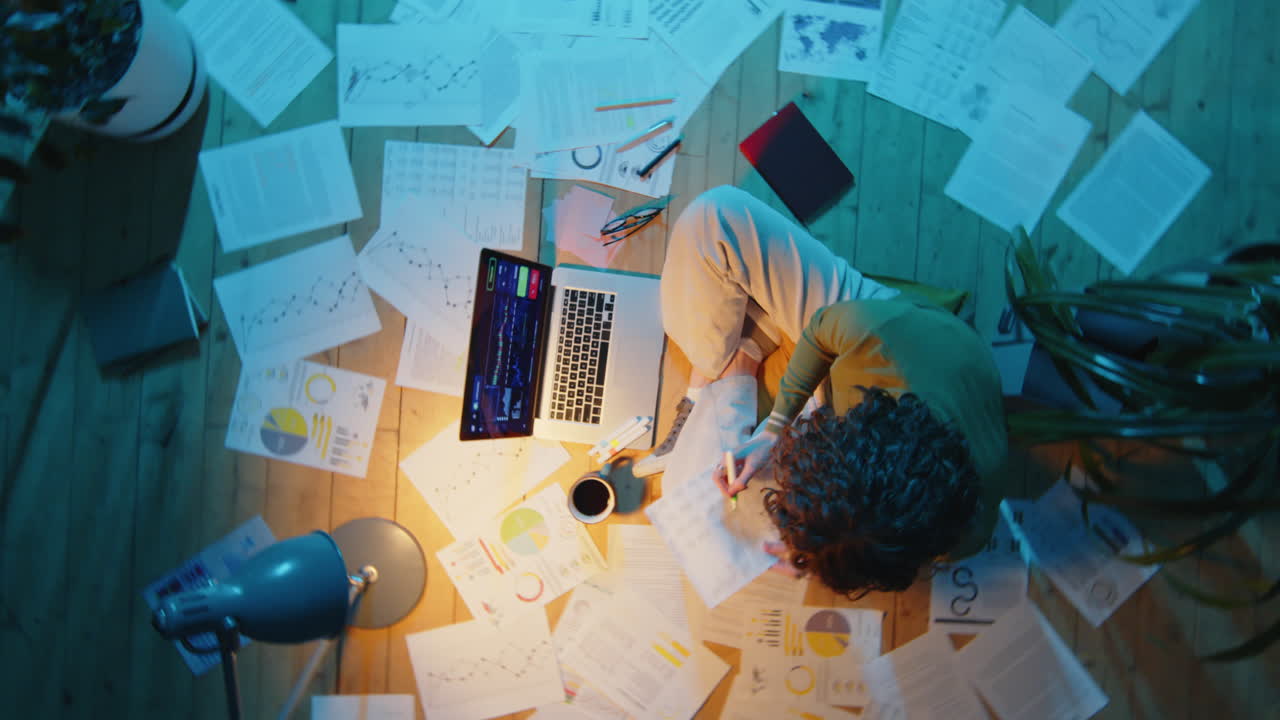 Woman Working with Financial Papers during Night