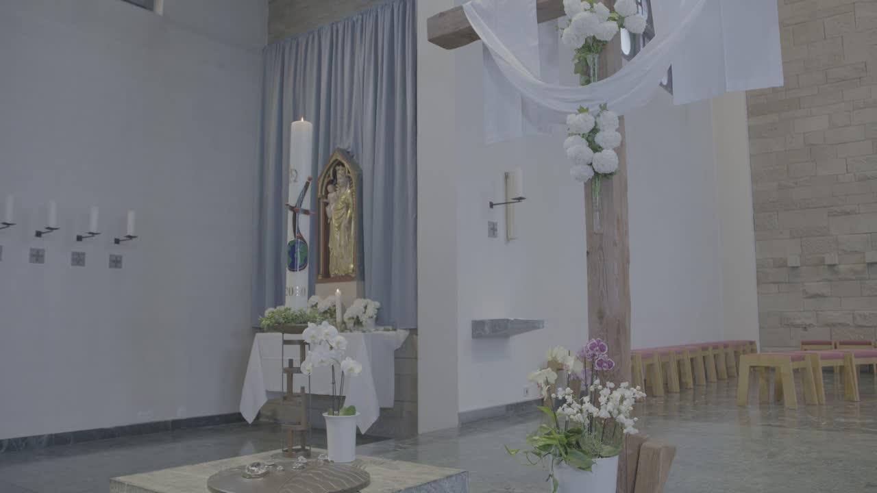 View of the baptismal font and the altar of Mary in a church at Easter