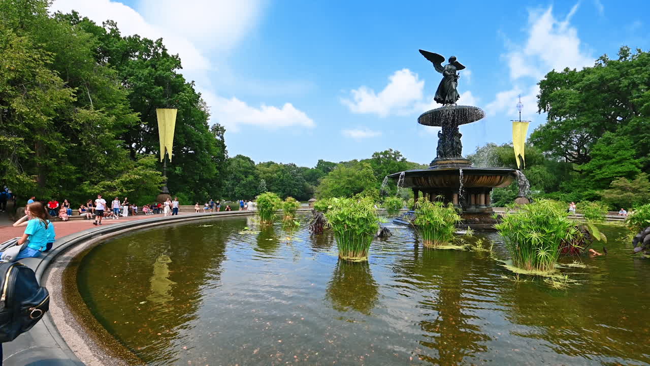 New York, USA, 28 July 2025: Visitors at bethesda fountain. People relax by the Bethesda Fountain in Central Park, surrounded by lush greenery and bright blue skies
