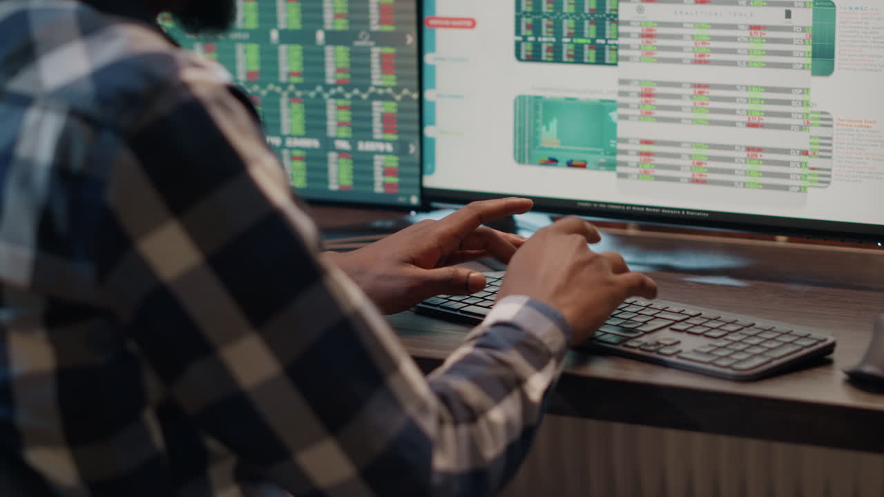 Financial consultant using multi monitors to create forex exchange plan
