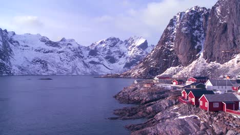 pan to an amazing view of a red fishing village in the arctic lofoten islands norway