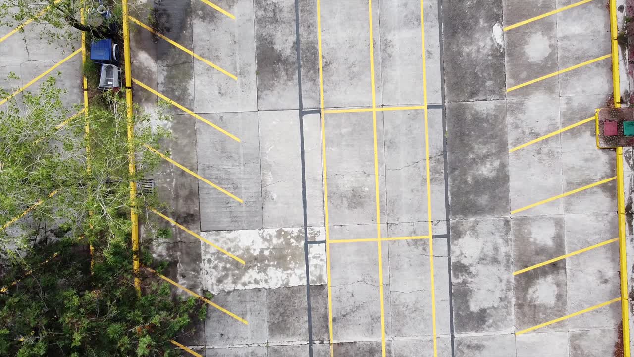 vista aérea vacía, desolada y desierta directamente sobre el estacionamiento en la universidad nacional autónoma de méxico, pandemia y cuarentena de covid-19, dron en ascenso