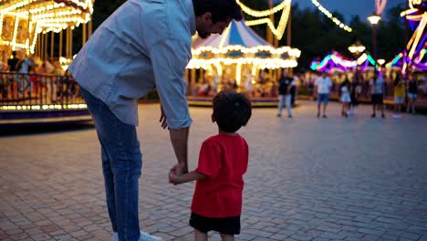 father and son at the night carnival