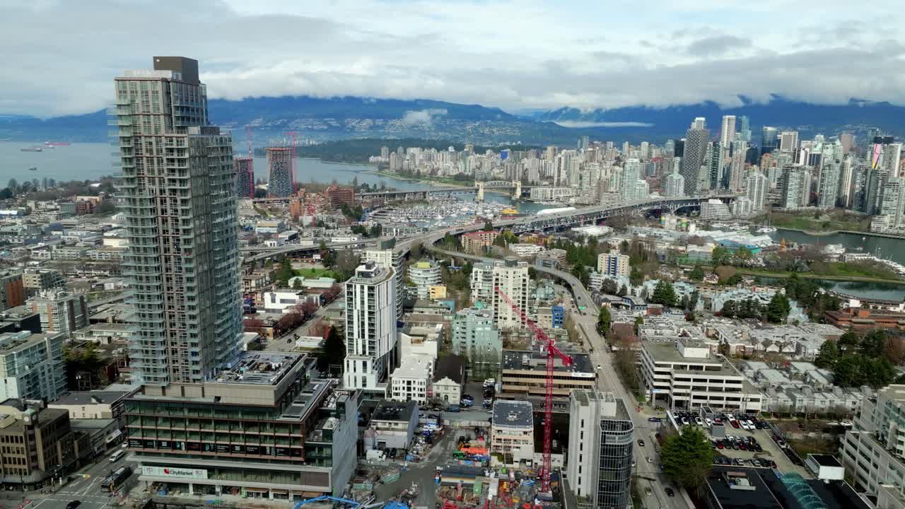 Construction of New Tower Building At West Broadway Overlooking Downtown Vancouver In BC, Canada. - aerial shot