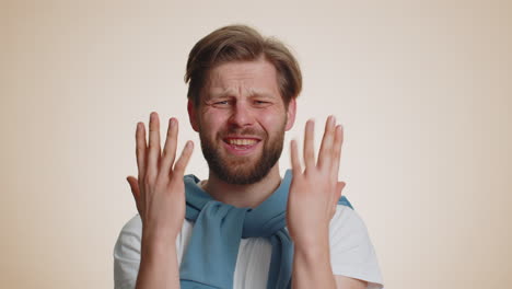 Bearded caucasian man loses becoming surprised by lottery results bad fortune loss unlucky news
