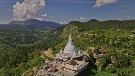 Ella-Sri-Lanka-Aerial-v22-drone-fly-around-hillside-Mahamevnawa-Buddhist-Temple-in-Bandarawela-town-capturing-stupa-and-panoramic-views-of-mountain-landscape---Shot-with-Mavic-3-Cine---April-2023