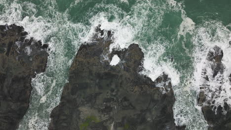 drone top down overview descends on thor's well, oregon coast