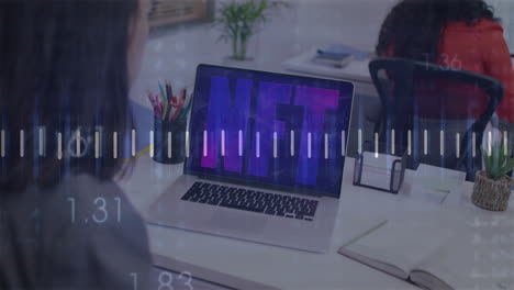 nft text animation over person working at desk with laptop