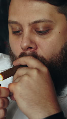 man smoking cigar. elegantly dressed man smoking cigar in studio vertical video