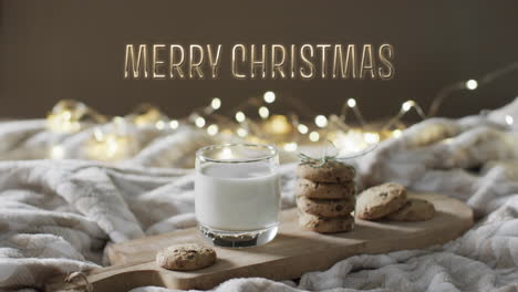 merry christmas text over christmas cookies and milk with string lights in background