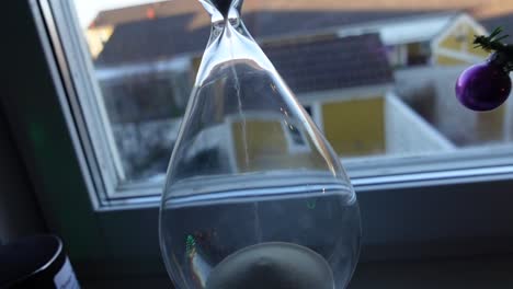 hour glass in front of the window