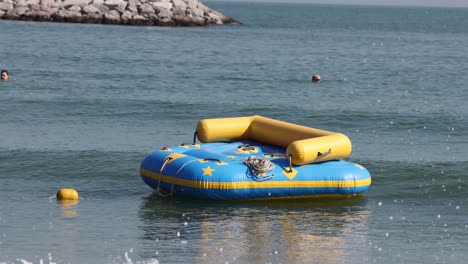 people enjoying a bumpy inflatable boat ride