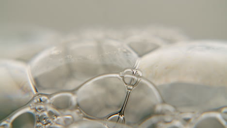 macro shot of dish soap forming transparent spheres