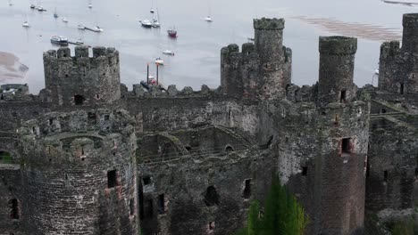 historic conwy castle aerial view of landmark town ruin stone wall battlements tourist attraction orbit rising right