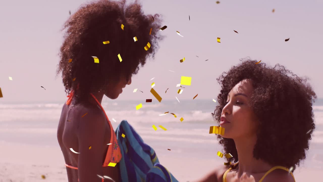Animation of christmas confetti over biracial woman with daughter on beach