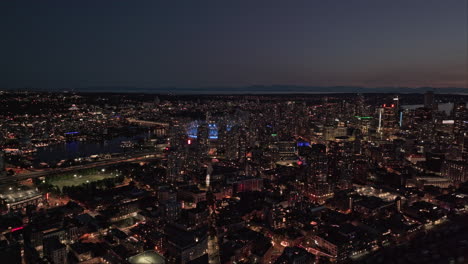 vancouver bc canada aerial v70 flyover eastside capturing illuminated gastown and waterfront downtown cityscape, industrial shipyard and harbour views at dusk - shot with mavic 3 pro cine - july 2023